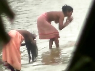 Indian women bathing by someone's skin river